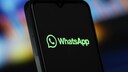 Smartphone Displays WhatsApp Logo and Text