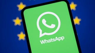 Smartphone with WhatsApp logo in the foreground. In the background, the European Union flag.