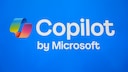 Alt-text: On a blue background, the colorful Copilot logo is displayed next to the white text "Copilot," with "by Microsoft" written underneath.
