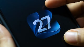 iOS 27 logo on iPhone screen, finger touching display