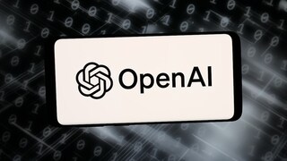 A smartphone or display shows the OpenAI logo and the word "OpenAI" against a bright background. In the background, there are blurred rows of zeros and ones, along with bright light streaks on a dark surface. The image resembles a graphic illustration related to artificial intelligence, software, and cybersecurity.