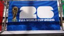 Blue sign for the FIFA World Cup 2026 featuring a large white "26," the golden World Cup trophy, and the text "FIFA World Cup 2026" in a covered hall.
