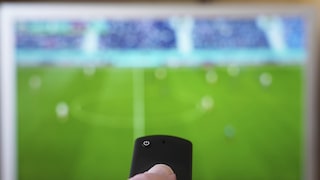 Person Points Remote at TV