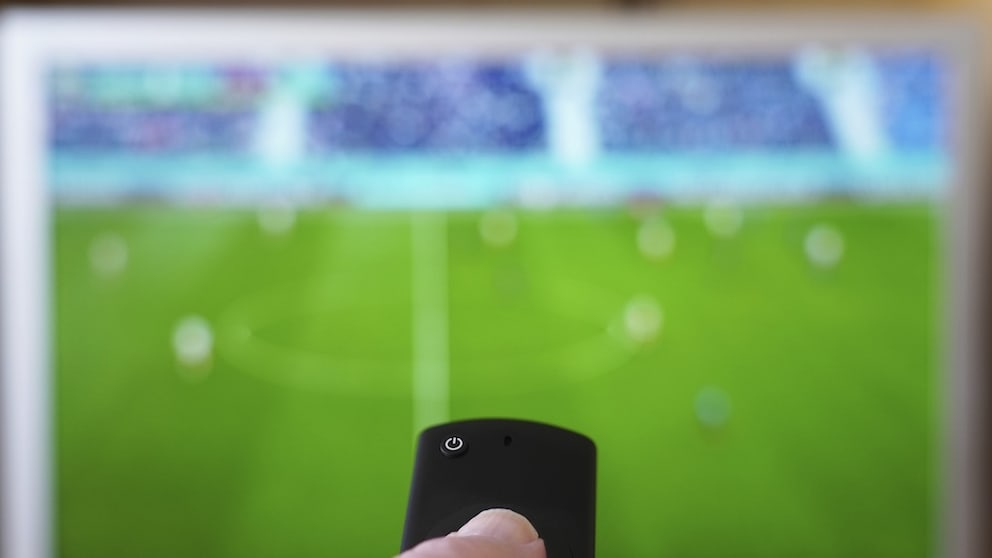 Person Points Remote at TV