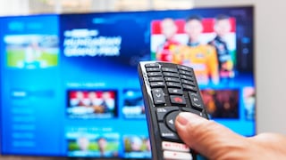 Person points a remote control at a television