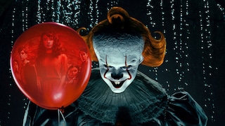Clown Pennywise grins directly at the camera