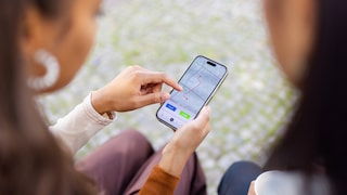 Women look at iPhone with maps app