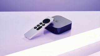 Apple TV and remote lie on a light-colored surface