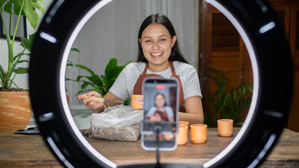Young woman speaks into her recording smartphone