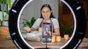 Young woman speaks into her recording smartphone