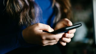 Woman Holds Smartphone in Her Hands