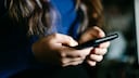 Woman Holds Smartphone in Her Hands