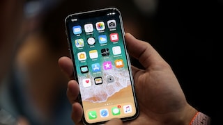Man Holds iPhone X in His Hands