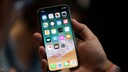 Man Holds iPhone X in His Hands