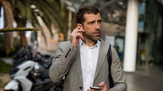 Businessman with smartphone and earbuds