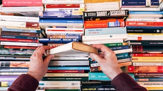 Person Digs Through Several Books