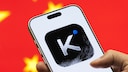 Logo of the Chinese AI app Kimi on a smartphone, with the Chinese flag in the background