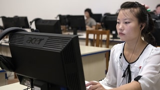 North Korean Woman in Front of a Computer Monitor