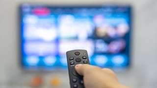 Person Points Remote at TV