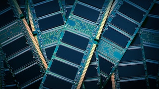 Several green RAM memory modules are stacked on top of each other. Visible are black memory chips, circuit traces, and gold-colored contact strips on the boards.
