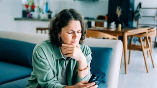 Woman with iPhone on Sofa