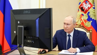 Putin in his office, staring at the computer screen