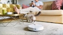 Man Relaxing at Home While Robot Vacuum Cleans