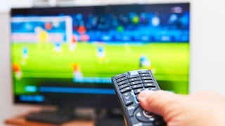 Person points a remote at a TV