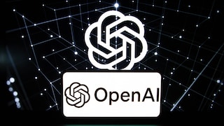 On a laptop screen, the OpenAI logo is displayed multiple times. In the background, glowing lines and dots form a digital network against a black backdrop. In the foreground, a white field with the OpenAI lettering and logo appears. The laptop's keyboard is visible at the bottom edge of the image.