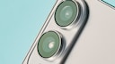 Close-up of the back of a silver smartphone featuring two large, vertically aligned camera lenses against a light blue background