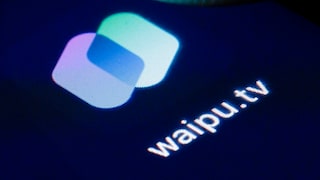 Close-up of the waipu.tv logo on a dark screen. The app icon features two overlapping, rounded rectangles in white, light blue, and violet, along with the text "waipu.tv."