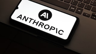 Anthropic logo is visible on a smartphone