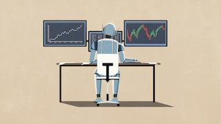 A robot sits at a desk and works on a computer.