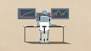 A robot sits at a desk and works on a computer.