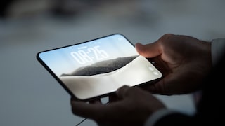 Man Holds iPhone Duo in Apple Store