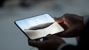 Man Holds iPhone Duo in Apple Store