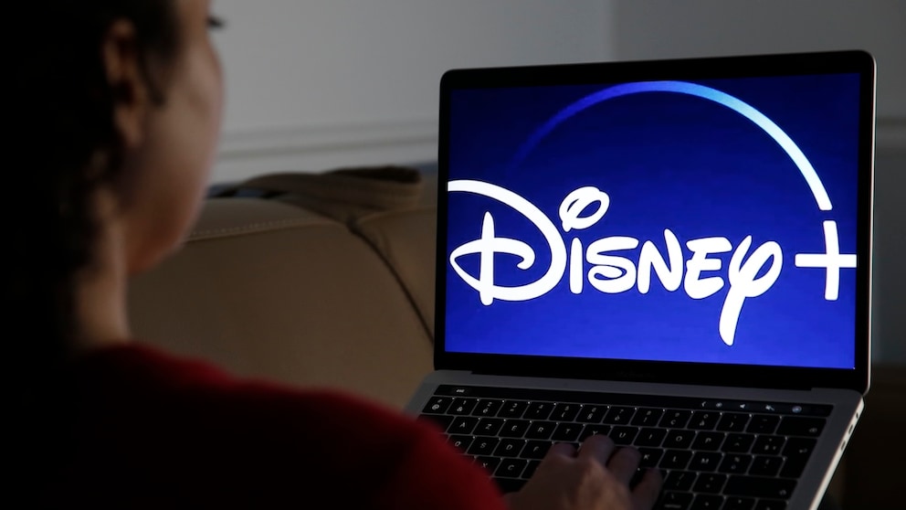 Woman Watches Disney+ on TV