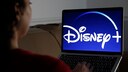 Woman Watches Disney+ on TV