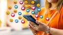 A woman uses her smartphone, with various emojis symbolically appearing above it.