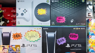 Several Xbox and PlayStation consoles in the store
