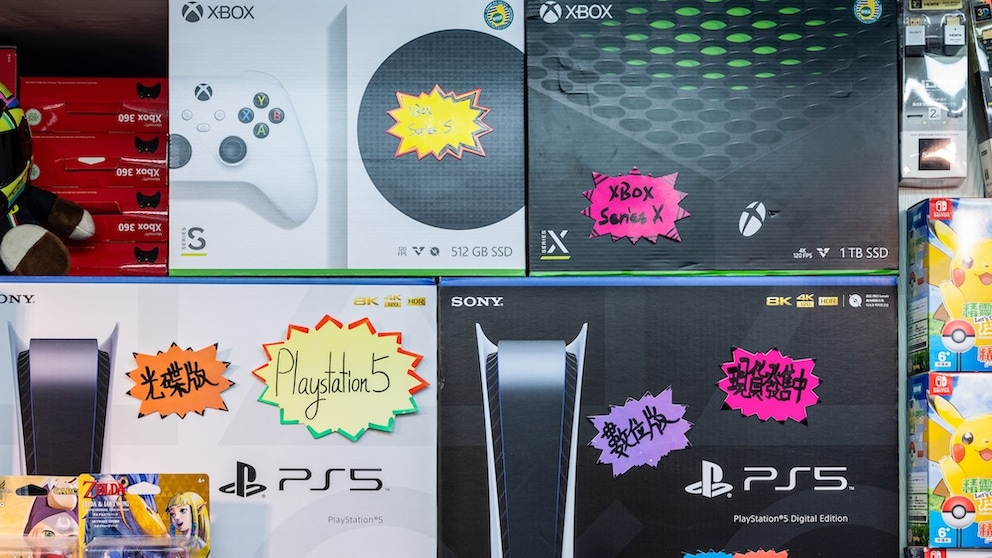 Several Xbox and PlayStation consoles in the store