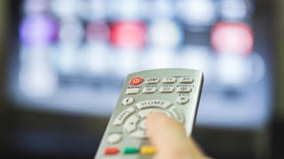 Person Points Remote at Television
