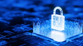 A symbolic image on the topic of data protection: A glowing digital padlock stands on a blue-lit circuit board, surrounded by stylized circuit traces.