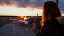 Woman Looks at Airplane