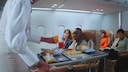 Flight Attendant Serves Drinks