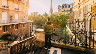 Traveler with Backpack in Front of the Eiffel Tower: Our Author Lists Five Things She Wishes She Had Known Before Her Trip to France