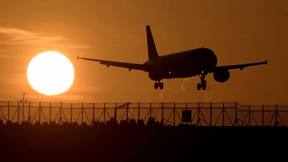 Airplane flies at sunset