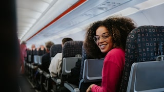Woman with more legroom on standard airplane seats