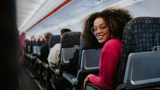 Woman with more legroom on standard airplane seats