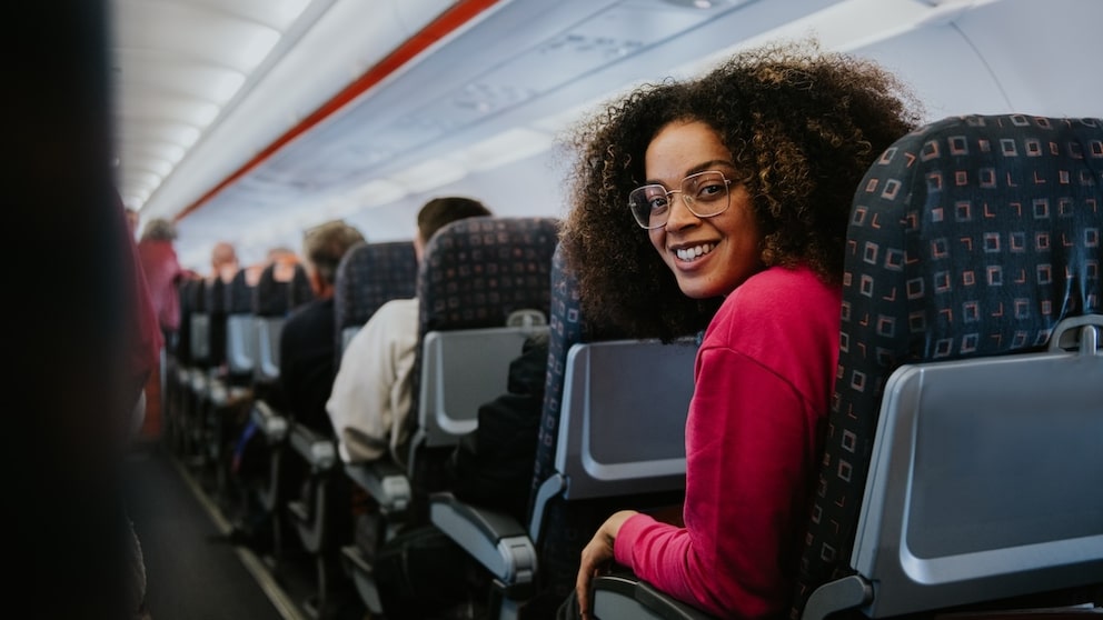 Woman with more legroom on standard airplane seats